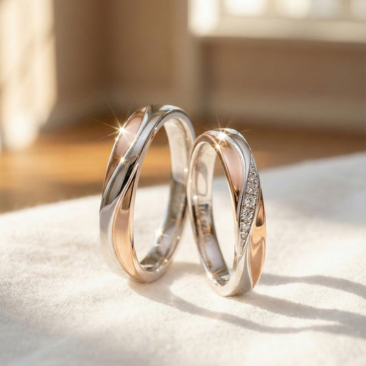 A set of white gold and rose gold wedding band. Lady's band has pave diamonds